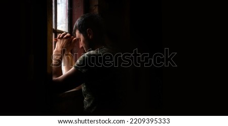 Tired pensive devote belief navy force young guy hero face cry hope hand pain love dark black old vintage retro home room text space. Worry human feel lost despair frown upset warfare believe concept Royalty-Free Stock Photo #2209395333