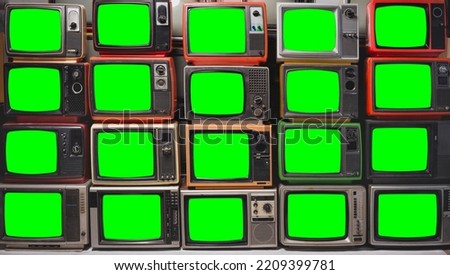Twenty vintage televisions with chroma key green screen for designer. Pattern wall of pile old retro TVs
