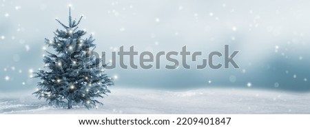 lighted isolated christmas tree in idyllic white snowy landscape, greeting card banner concept with copy space for december holiday season, christmas background