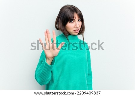 Young caucasian woman isolated on white background rejecting someone showing a gesture of disgust.