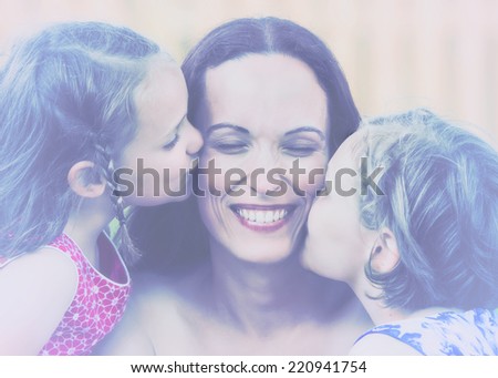 A close up family picture of two daughters on either side of their mother each giving a kiss on her cheek.  Filtered for a retro, vintage look. 