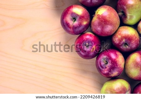 Concept for an simple autumn background. Close-up of fresh, organic apples on a wooden table. Flat lay, top view. Copy space.