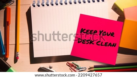 Composite of keep your desk clean text on sticky note and high angle view of office supplies. Desk, stationery, hygiene, awareness, celebration concept.
