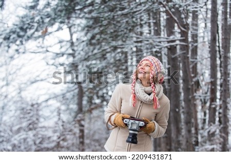 Trendy and stylish. woman hold photo camera. make photo shot of snowy winter nature. cold and beautiful weather. happy hiker girl retro camera. professional photographer winter landscape