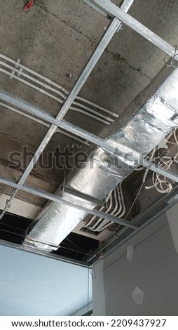 Air conditioning ducting with ceiling frame 