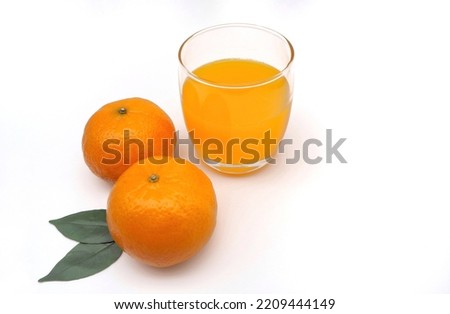 Close up glass juice and two fresh orange mandarin with white background, concept vitamin C, natural, organic, beauty, product, health nutrition, drink