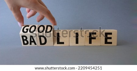 Good life and Bad life symbol. Businessman hand. Turned cubes with words Good life and Bad life. Beautiful grey background. Business concept. Copy space