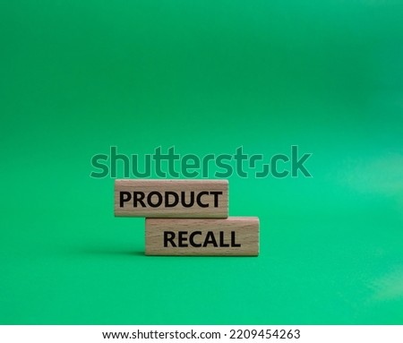 Product recall symbol. Concept words Product recall on wooden blocks. Beautiful green background. Business and Product recall concept. Copy space.