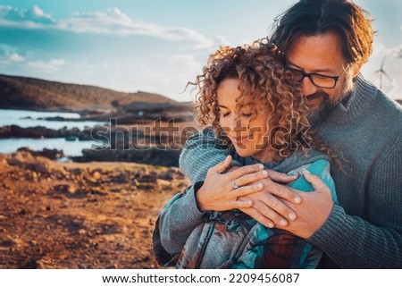 Happy young couple in love hugging outdoors with tenderness and relationship. Concept of travel lifestyle. Man and woman embracing with scenic nature background outdoors. Leisure love people vacation Royalty-Free Stock Photo #2209456087