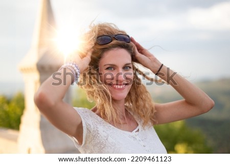 Balanced Caucasian positive woman with toothy smile outdoor portrait