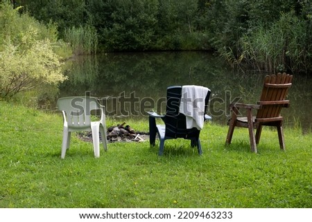 Three chairs around a little pond