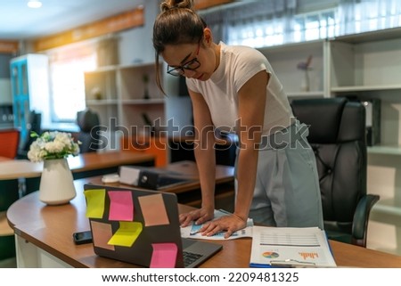 Asian businesswoman tired on business work. young adult exhausted office woman work late  at workplace feel alone and sad. quite serious sad female worker think about life after over work at office. Royalty-Free Stock Photo #2209481325
