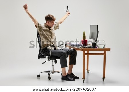 Success, wow. Happy and cheerful student sitting at computer desk and studying. Business, emotions, studying, home education, youth, remote workplace concept.Copy space for text