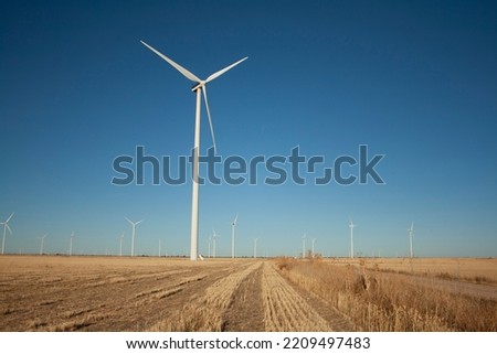 windmills producing electricity in the fields of Castilla Royalty-Free Stock Photo #2209497483