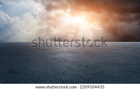 Empty asphalt race track road with beautiful sky clouds at sunrise
