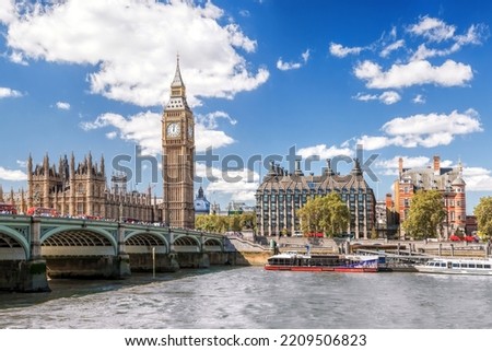 Famous Big Ben with bridge over Thames and tourboat on the river in London, England, UK Royalty-Free Stock Photo #2209506823