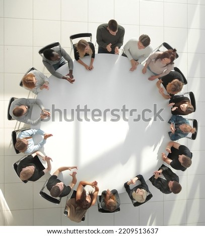 top view. young people shaking hands at a round table meeting