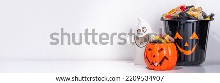 Happy halloween kids holiday background. Various set of halloween holiday buckets with sweets, candies. Trick or treat concept, save space