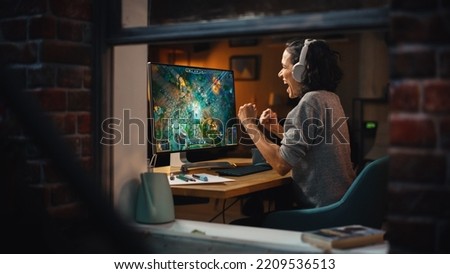 Cheerful Female Gamer Playing Online Video Game on Personal Computer. Professional Woman Player Enjoying Fantasy RPG and Celebrating Victory. Role Playing Character Casting Magic Spells. Window View.