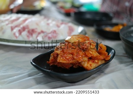Korean style of eating fresh sashimi and aged kimchi together