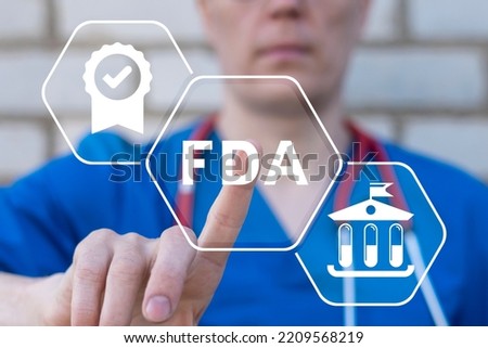 Doctor using virtual touchscreen presses abbreviation: FDA. Concept of FDA Food and Drug Administration Health Product Standard Control System. Royalty-Free Stock Photo #2209568219