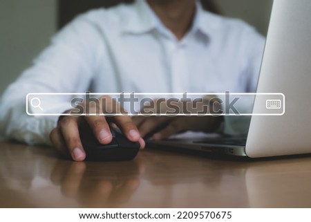 Close up image hand of young businessman using laptop with search engine icon and use the search engine menu to find information on the Internet.