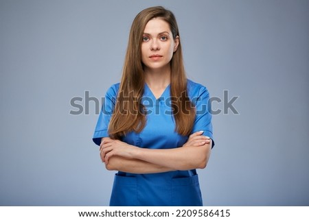 Serious nurse woman in blue medical uniform. Isolated female portrait. Royalty-Free Stock Photo #2209586415