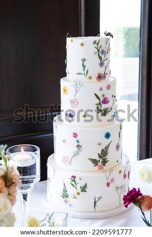 Beautiful large 4 tiered wedding cake with spring floral designs