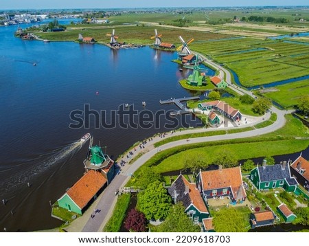 Zaanse Schans windmills and the famous Dutch canals near Amsterdam. Aero Photography. View from flying drone.Panoramic cityscape of old town of Zaandam, Netherlands, Europe. Top View