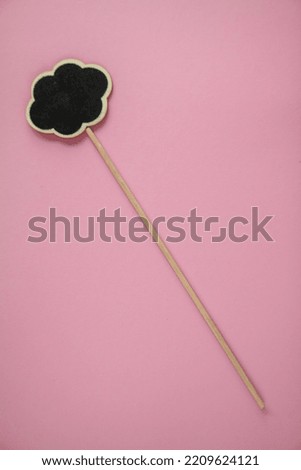 A stick with a sign for writing on a bright background
