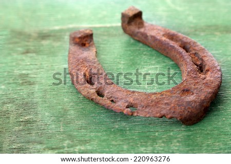 Old horse shoe on wooden background