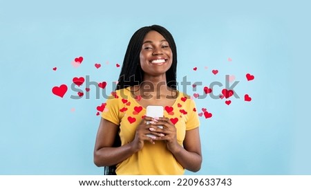 Toothy Black Lady Holding Smartphone Smiling To Camera Posing Over Blue Studio Background. Female With Mobile Phone Using New Application, Got Love Message From Lover, Collage Royalty-Free Stock Photo #2209633743