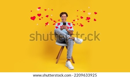 Contented Casual Man Using Smartphone Checking New Dating Mobile Application, Chatting With Ladies Texting Online, Sitting In Chair, Yellow Studio Background, Collage, Panorama Royalty-Free Stock Photo #2209633925
