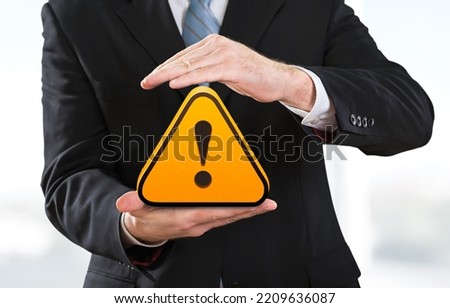 Warning sign image hold by businessman for warning