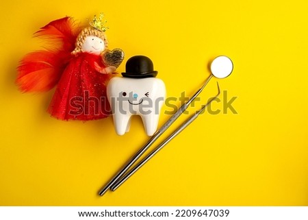 tooth fairy and tooth figurine and dental tools