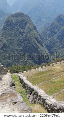 The city of Inca Machu Picchu on the top of a mountain, with neighboring high mountains, its dizzying environment, its well-polished stone walls, its natural garden and its historical construction