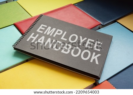 An employee handbook on the colorful books. Royalty-Free Stock Photo #2209654003