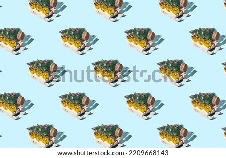 Pattern of christmas tree on sleigh toy on blue pastel background