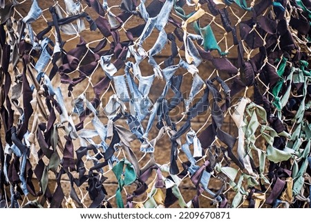 abstract background from a camouflage military mesh close-up. war in Ukraine
