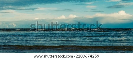 View of the sea coast, evening sunset in dark clouds