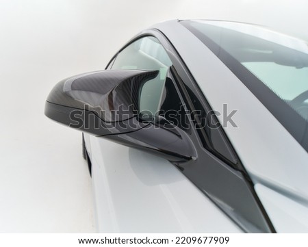 Carbon fiber car exterior elements with unique designe in white studio close up