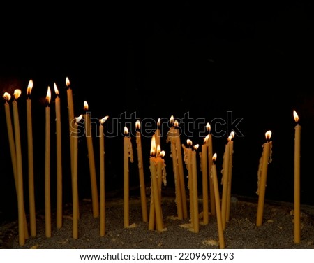 Burning thin candles as offerings