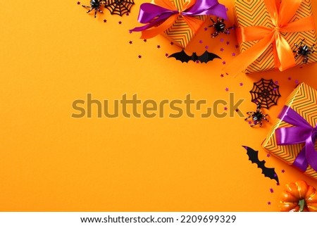 Happy Halloween holiday banner template with gift boxes, spiders, bats, confetti on orange background. Flat lay, top view, copy space.