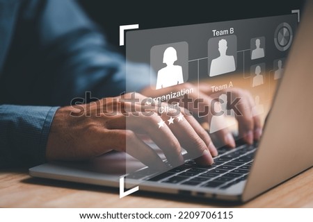 Businessman using laptop computer with mindmap or organigram on virtual screen. Human Resources Manager working with HR organizational diagram, career concept. Royalty-Free Stock Photo #2209706115