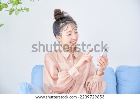 Young woman using smartphone in the room