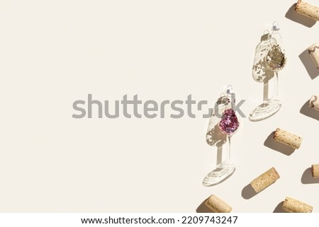 Wine corks and Christmas decoration as wine glass on beige background, hard light at sunlight. Creative bright minimal flat lay, sparkling new year background with copy space, holiday drink concept