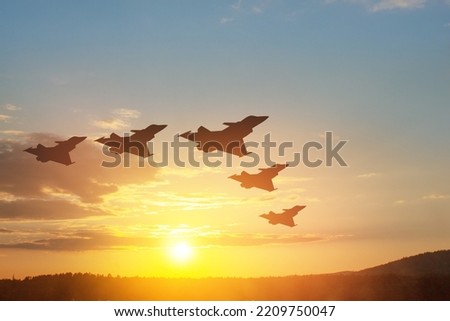 Air Force Day. Aircraft silhouettes on background of sunset. Royalty-Free Stock Photo #2209750047