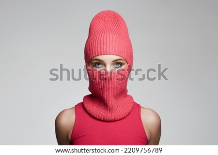 beautiful girl in red balaclava. New Hat style. Trendy Mask on pretty woman Royalty-Free Stock Photo #2209756789