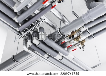 Materials for plumbing on a white wall background Royalty-Free Stock Photo #2209761755