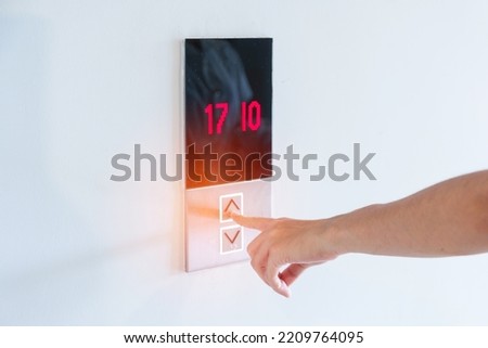 Hand finger press the Elevator button, woman waiting for Elevator in office or apartment